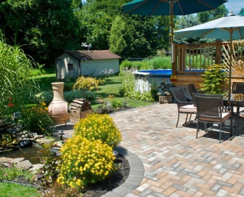 paver patio with lush landscaping - Spade Landscaping patio design