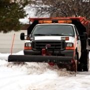 truck plowing through snow - Spade Landscaping snow plowing services