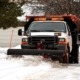 truck plowing through snow - Spade Landscaping snow plowing services