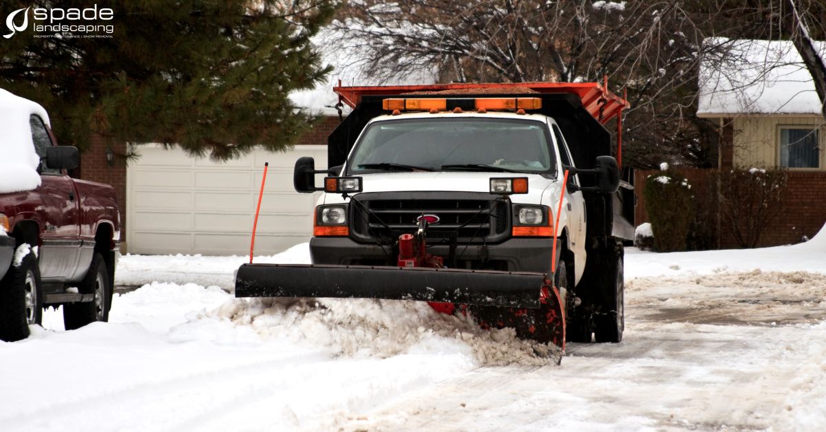 truck plowing through snow - Spade Landscaping commercial snow plowing services