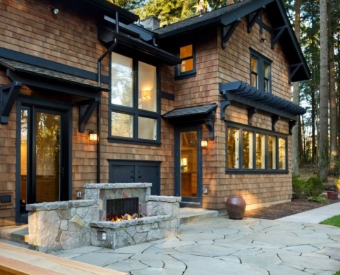 back of home with a stone outdoor fireplace - Spade Landscaping outdoor fireplace