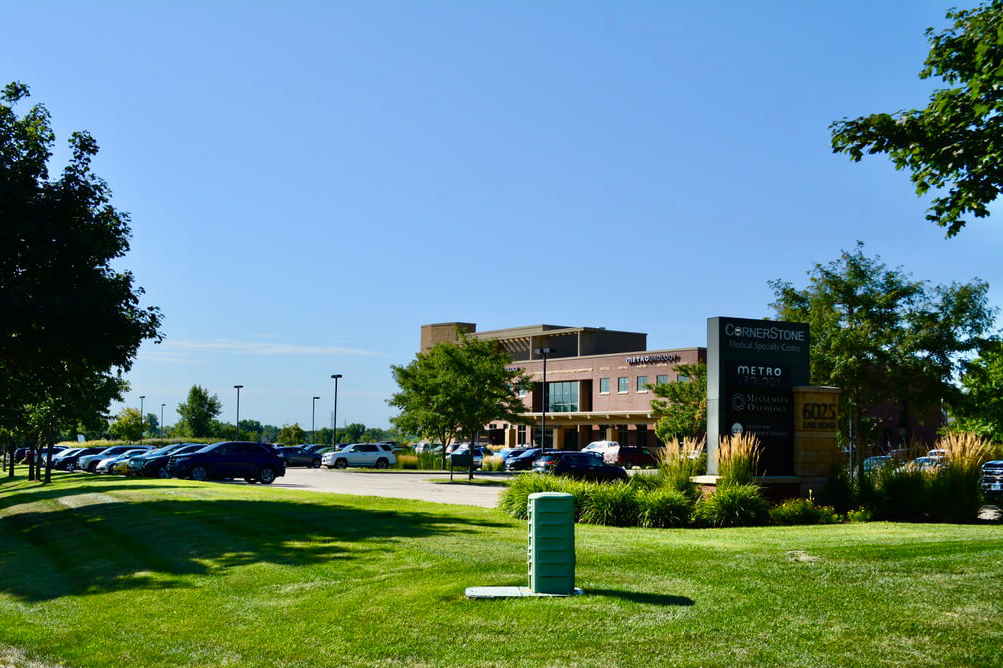 freshly mowed grass outside a commercial building - Spade Landscaping