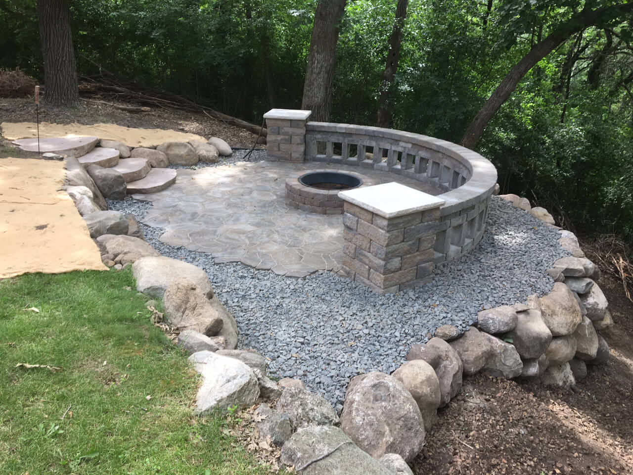 fire pit with large rocks - Spade Landscaping