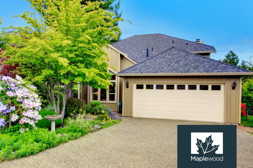 exterior of a suburban home with green plants and trees - Spade Landscaping Landscaping Maplewood MN