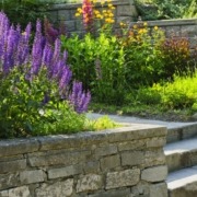stone retaining walls with flowers and plants - Spade Landscaping commercial landscaping services