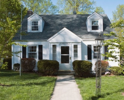 exterior of a white home with a flat front yard - Spade Landscaping lawn care services near Forest Lake, MN