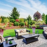backyard with a patio and green grass - Spade Landscaping residential landscaping services