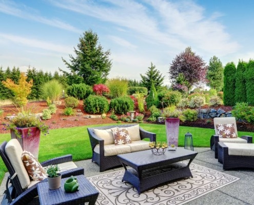 backyard with a patio and green grass - Spade Landscaping residential landscaping services