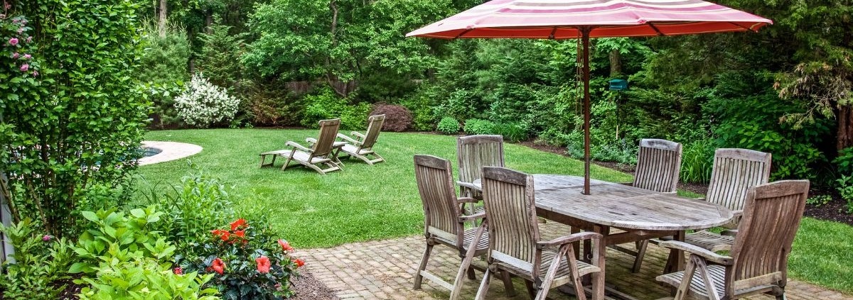 backyard with a patio and green grass - Spade Landscaping Lawn Care Services Near Hugo MN