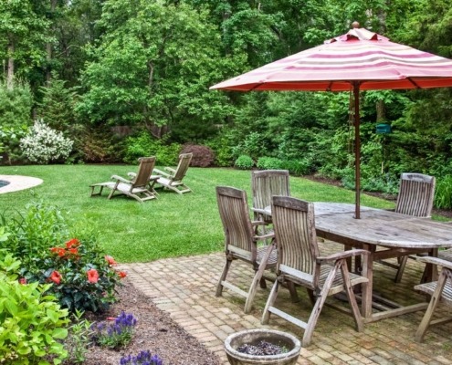 backyard with a patio and green grass - Spade Landscaping Lawn Care Services Near Hugo MN